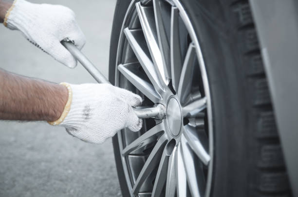 istock Changing car tire. Car service. Tire installation concept 1218712548