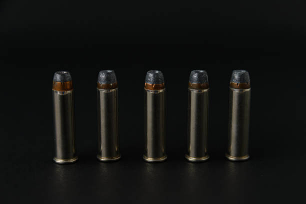 istock 357 magnum hollow point bullets lined up in row on black background 1218714422