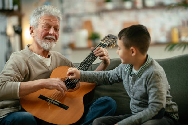 istock Grandfather and grandson playing guitar. 1218715466