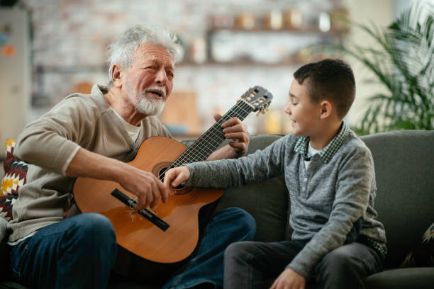 istock Grandfather and grandson playing guitar. 1218716317