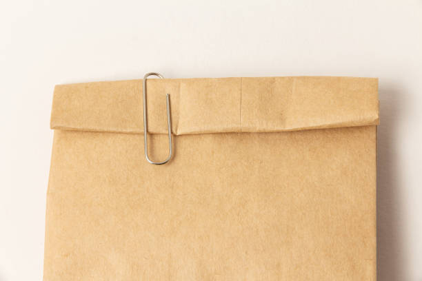 istock paper clip and closed paper bag 1218716575