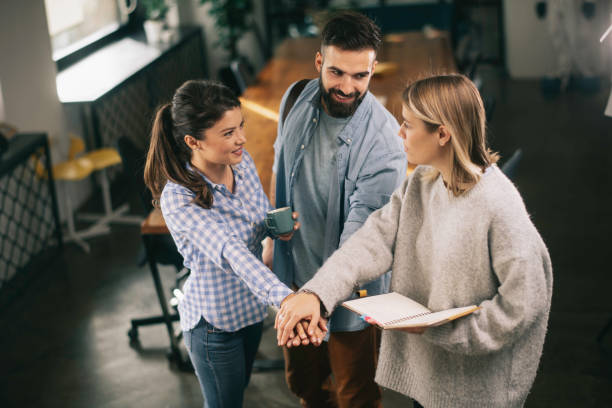 istock Business people putting their hands together. 1218716751