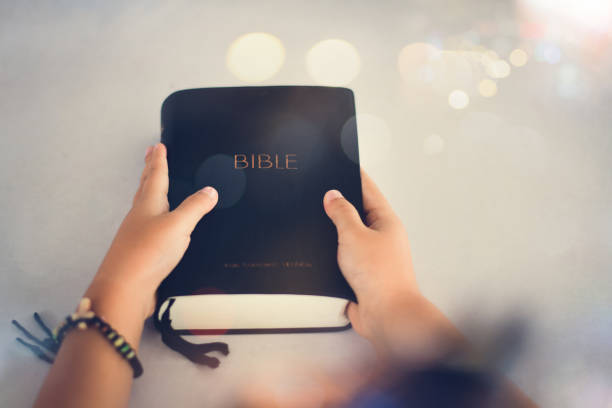 little hands on bible. she is reading and praying over bible