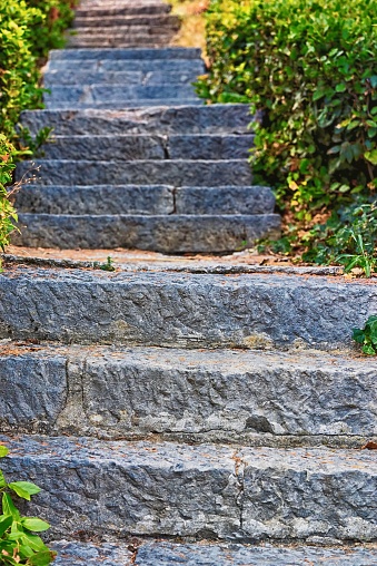 Old staircase with stone steps in the park outdoors closeup for an abstract background