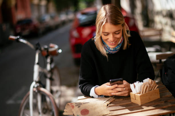 istock Young woman using the phone in cafe 1218718558