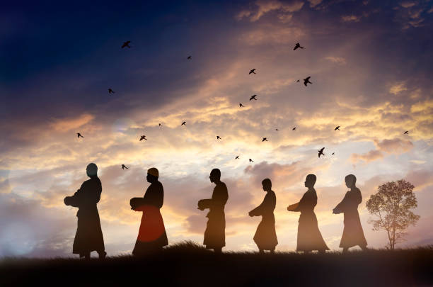 Silhouette Monks alms in the morning,Thailand stock photo