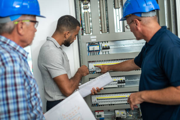 istock Electricians discussing with home owner 1218720422