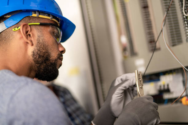 Electrician cutting wire Close up of young electrician cutting wire with cutter. wire cutter stock pictures, royalty-free photos & images