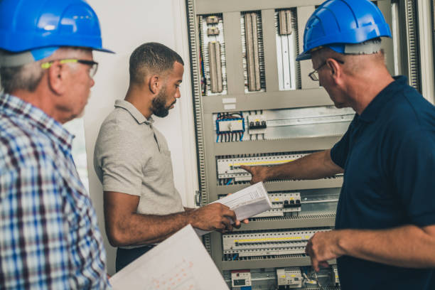 istock Electricians discussing with home owner 1218720448