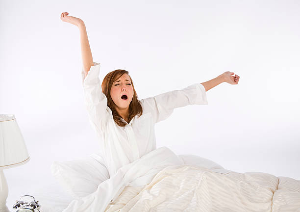 istock Young Woman in a White Bedroom 121872052