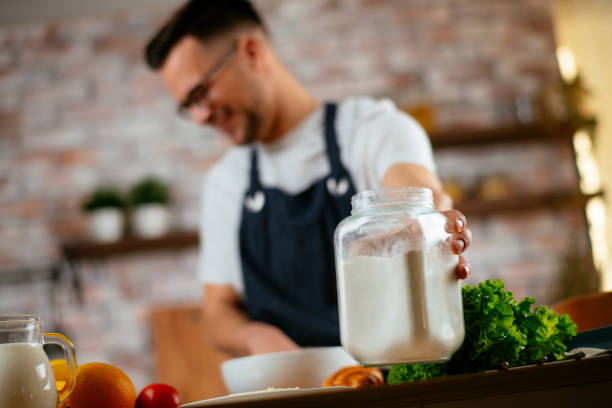 istock Young handsome man making delicious food in kitchen. 1218721198