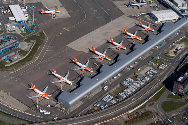 Aerial view of Easyjet Airbus airplanes at Schiphol Airport. Amsterdam, Holland, March 25, 2020. At Schiphol Amsterdam International Airport airplanes are grounded due to the Corona virus crisis. These orange and white coloured aircrafts are parked at Schiphol M-gate. stranded stock pictures, royalty-free photos & images