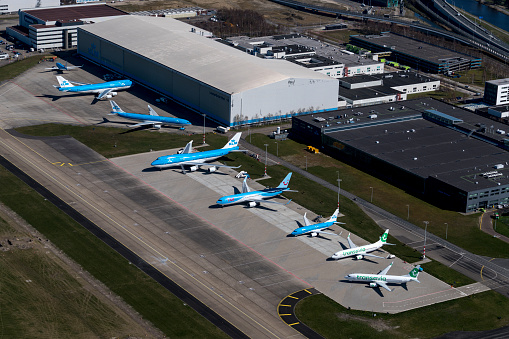 Amsterdam, Holland, March 31, 2020.  Because of the Corona crisis most jet airplanes are grounded due to government regulations. These aircrafts of TUI, Transavia and KLM Royal Dutch Airlines are parked at Schiphol Oost.