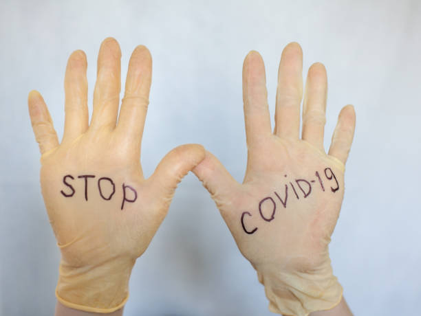 istock Stop Covid-19. Text on medical gloves. 1218721725