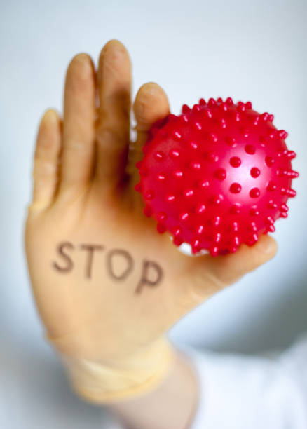 istock Stop Covid-19. Text on medical glove. 1218721730