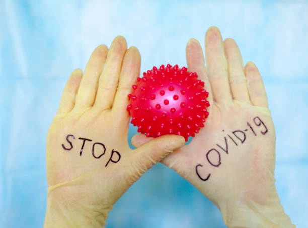 istock Stop Covid-19. Text on medical gloves. 1218721732