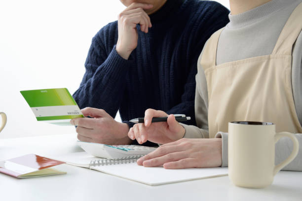 istock Japanese couple thinking about housekeeping budget 1218722187