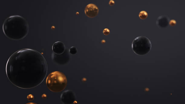 Shiny black and gold three dimensional spheres floating