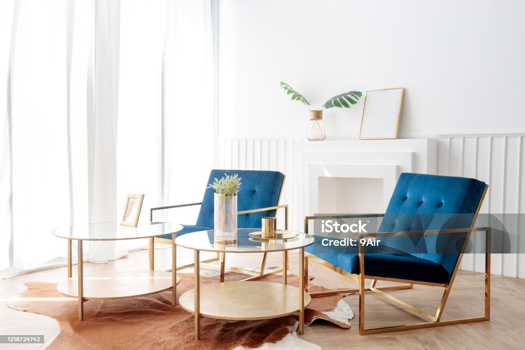 interior view of two elegance comfortable armchair and gold glass coffee table in living room interior view of two elegance blue comfortable armchair and gold glass coffee table in living room with white curtain Office Stock Photo interior view of two elegance comfortable armchair and gold glass coffee table in living room interior view of two elegance blue comfortable armchair and gold glass coffee table in living room with white curtain Office Stock Photo