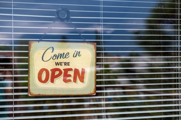 istock Come in we're OPEN sign on Entrance Window 1218724865