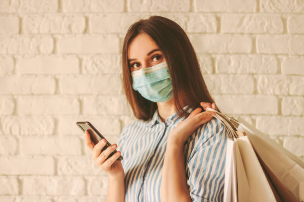 istock Young female shopper using mobile phone for shopping 1218724991