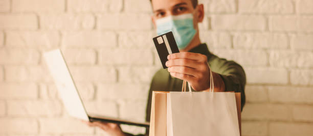 istock Man shopping online at home 1218725609