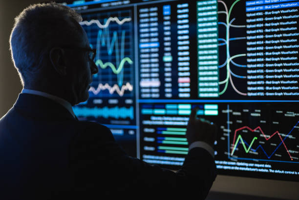 istock The old businessman working on the big sensor display 1218726248