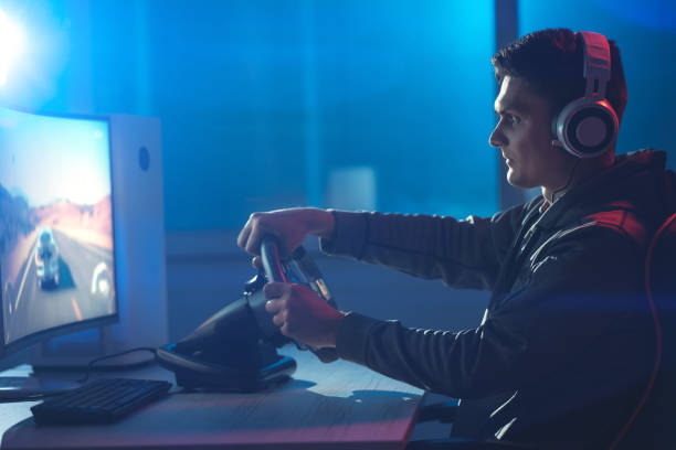 istock The guy gamer with headphones playing video game on his personal computer 1218726661
