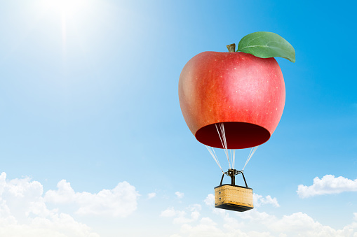 3D apple hot air  balloon floating in the blue sky; Air travel and aircraft, Tourism and recreation. Sky objects., Cute balloon