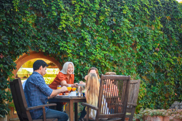 istock Spanish Family Enjoying Breakfast in Lush Green Courtyard 1218730351