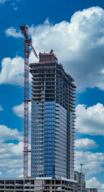 istock Red Crane by Steel and Glass Skyscraper 1218731123