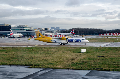 Gatwick, UK - January 3, 2020: Aurigny Air Services ATR 72 plane waiting to fly from Gatwick Airport, Sussex on a sunny January morning.