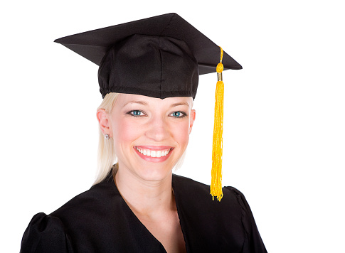 A smiling young woman wearing a graduation cap and gown.
