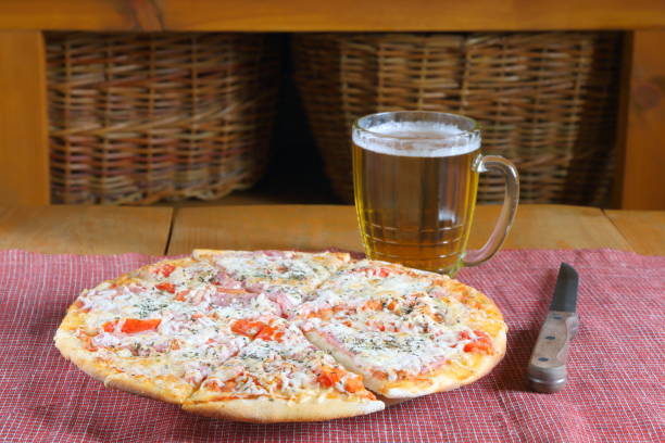 istock Cooked pizza and mug of beer. 1218732934