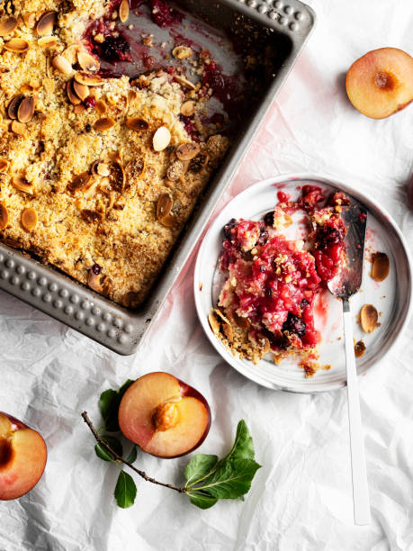 Plums crumble pie, crumble, fruit crumble,Crumble with plum, Crumble with Plums and nuts on a white background, Sweet