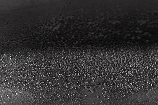 istock drops of water are sprayed on a black reflective glass 1218734786