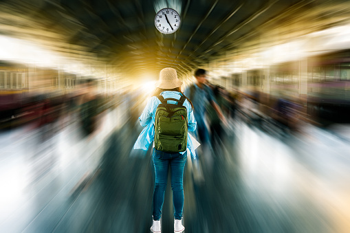 Blurred motion speed train background with solo woman traveler waiting depart time at platform