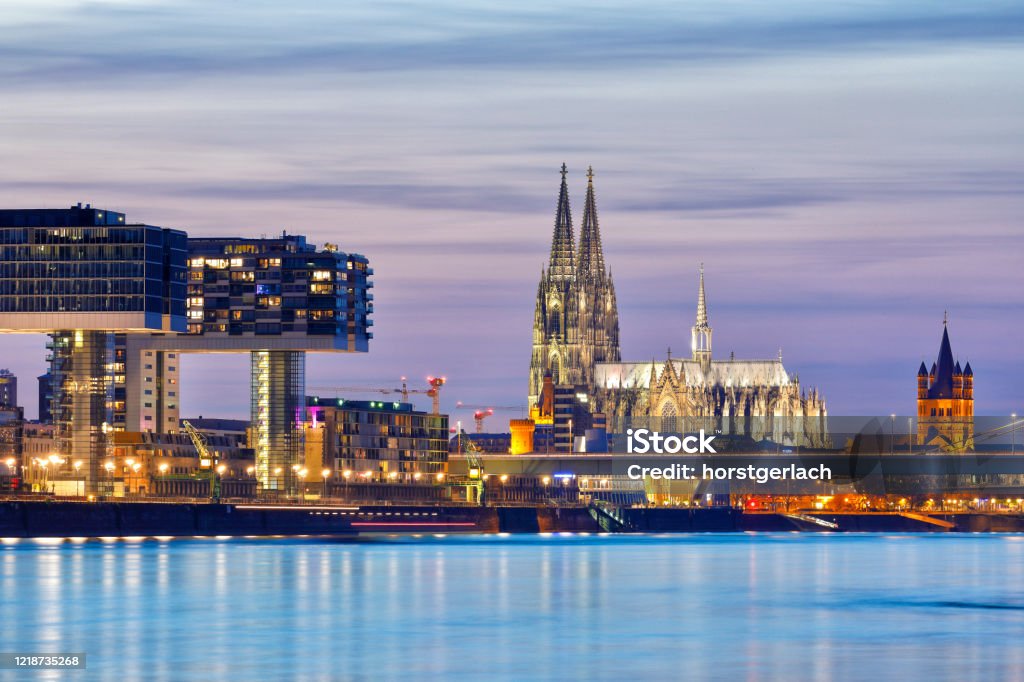 Rheinauhafen and Cologne Cathedral at Night Illuminated Crane Buildings and Cologne Cathedral at night. Cologne Stock Photo