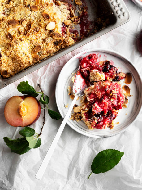 istock Plums crumble pie, crumble, fruit crumble,Crumble with plum, Crumble with Plums and nuts on a white background, Sweet 1218736584