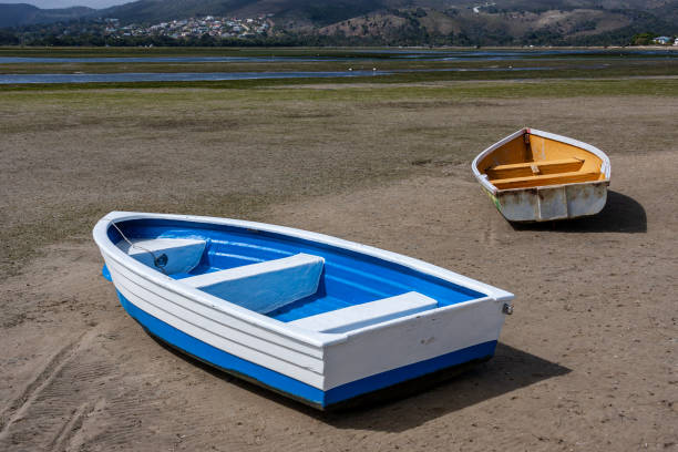 istock Blue and yellow dinghy's beached by the low tide 1218736839