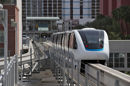 United States - Nevada - Las Vegas - The white driverless automatic las vegas 4-cars monorail train goes between two downtown stations