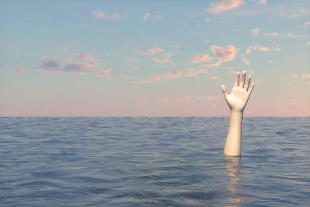 istock Hand of sinking man on the sea 1218737987