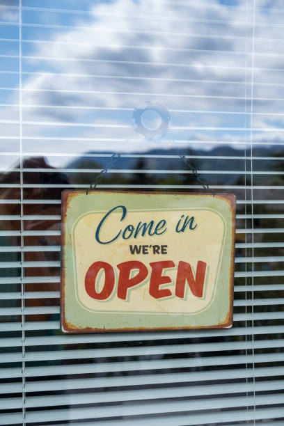 istock Come in we're OPEN sign on Entrance Window 1218741102