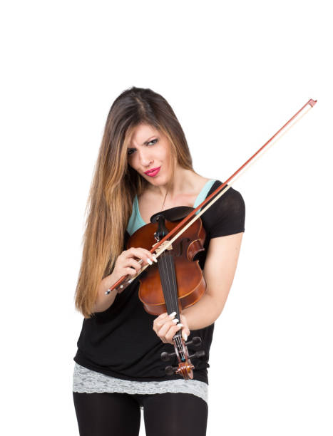 istock beautiful woman play her violin 1218741143