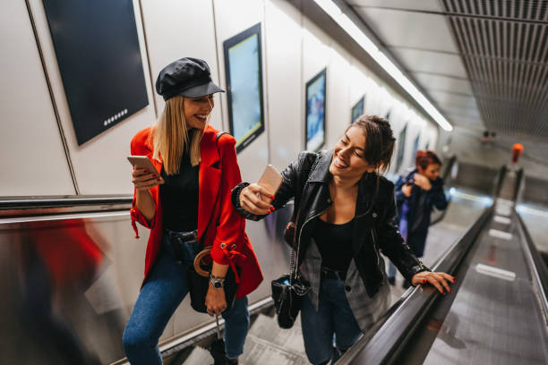 istock Female friends on subway escalator 1218741480