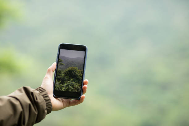 istock Hiker hands taking picture with mobile phone in spring nature 1218742017