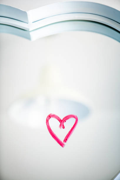 Lipstick heart shape on a heart shed mirror