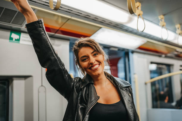 istock Beautiful young woman in subway train 1218743251