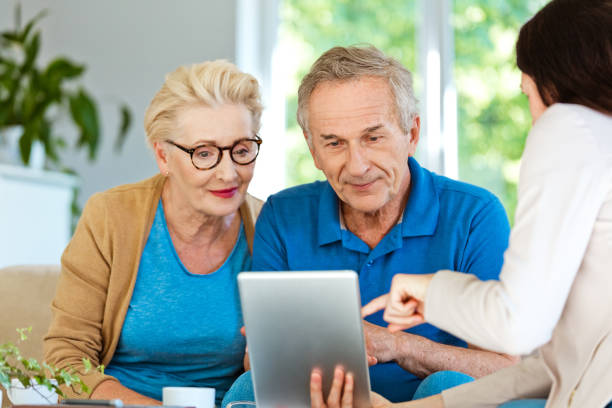 istock Financial advisor discussing contract with elderly couple 1218743701