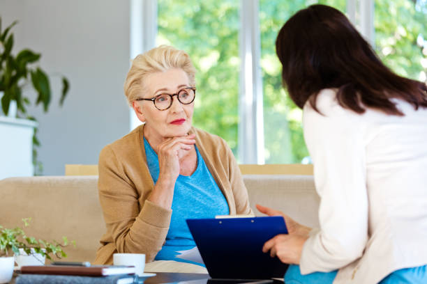 istock Insurance agent explaining agreement to senior woman 1218743938